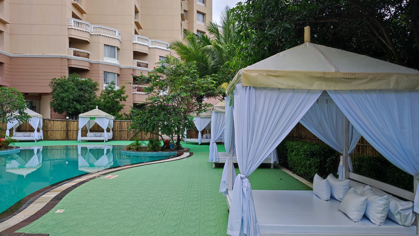 Poolside cabanas surrounded by tropical gardens