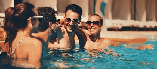 Friends enjoying an evening gathering in a pool